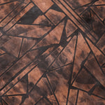 Close-up of a cowhide rug in mottled brown with a geometric brown overlay.