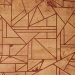 Close-up of a cowhide rug in mottled tan with a geometric brown overlay.