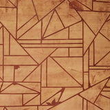 Close-up of a cowhide rug in mottled tan with a geometric brown overlay.