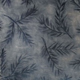 Close-up of a cowhide rug in gray with a black botanical overlay.