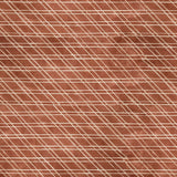 Close-up of a cowhide rug in brown with a white lattice overlay.