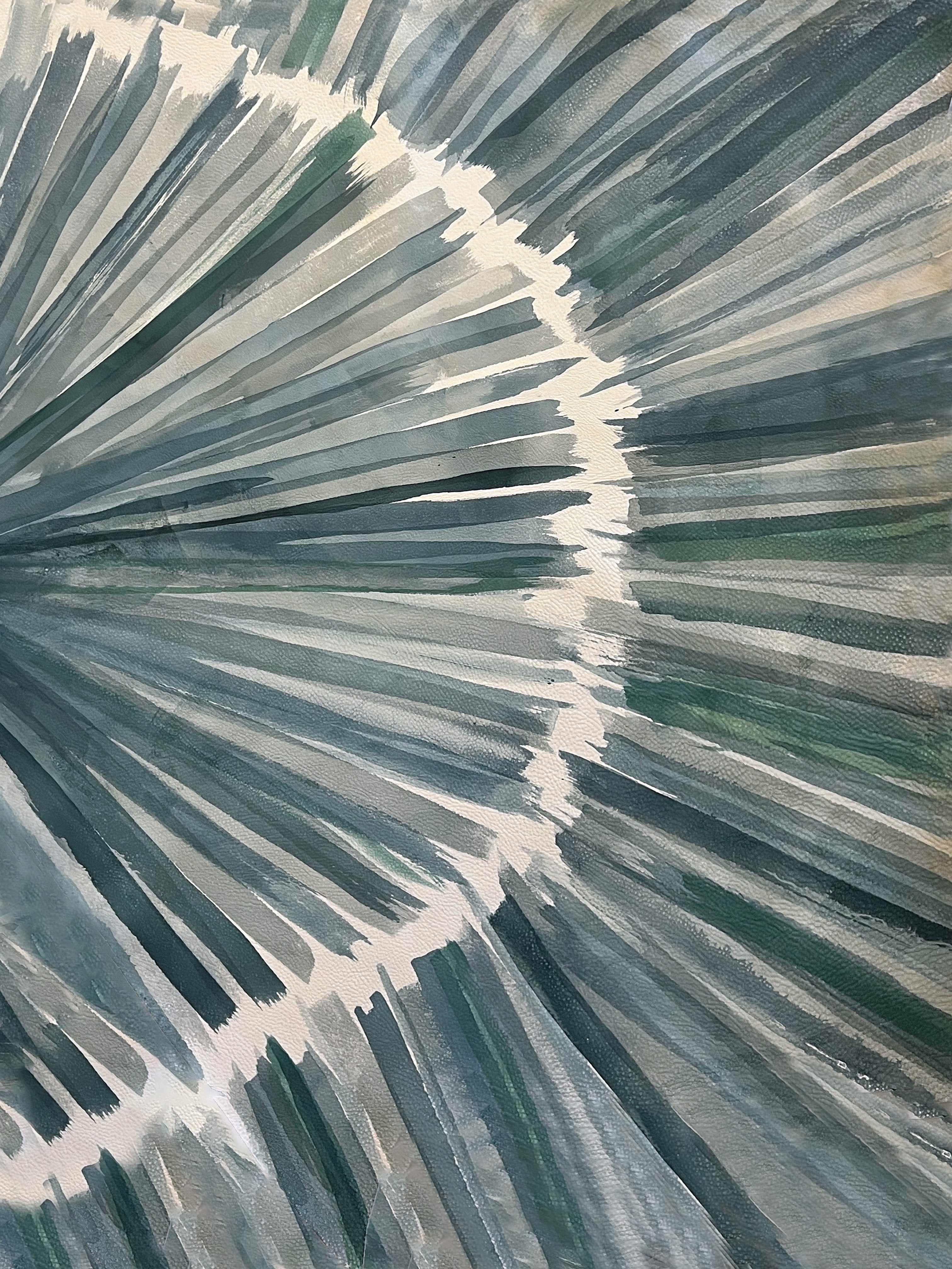 Close-up of a cowhide rug in cream with an abstract painterly overlay in shades of green and gray.