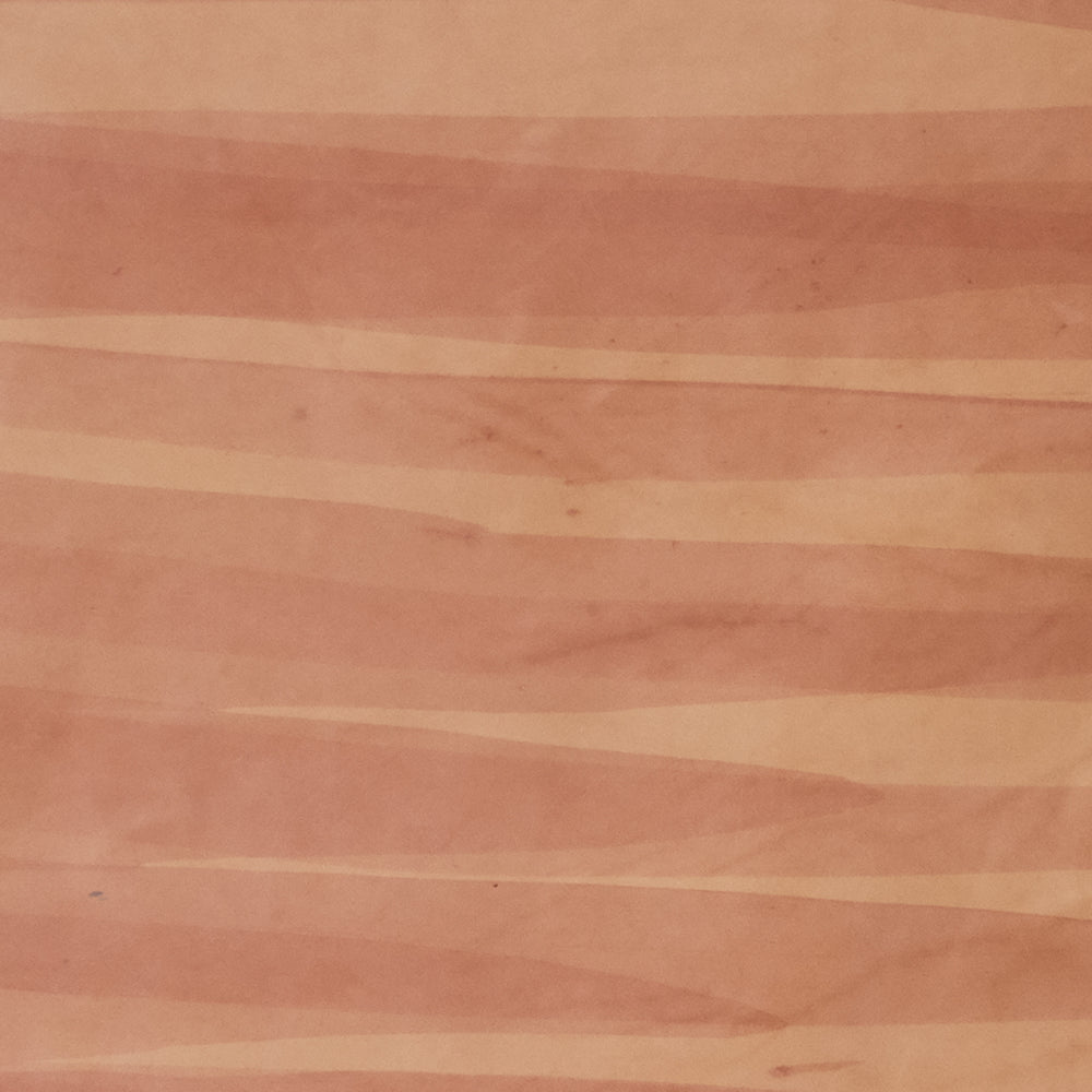 Upholstery leather in orange with an abstract stripe overlay in shades of orange and brown.