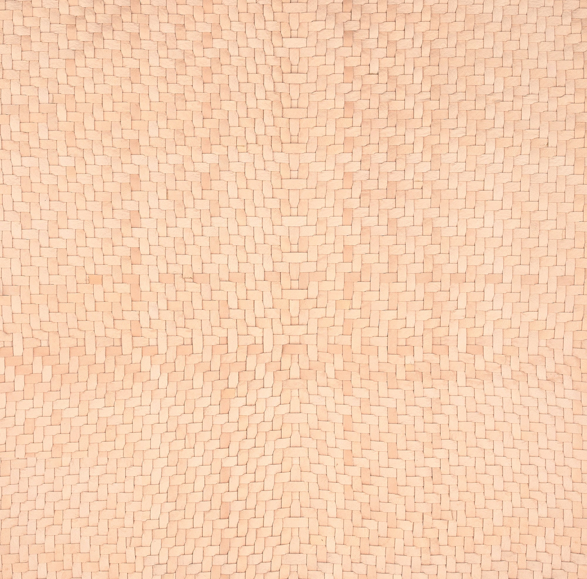 Close-up of tan upholstery leather yardage in a basket weave.