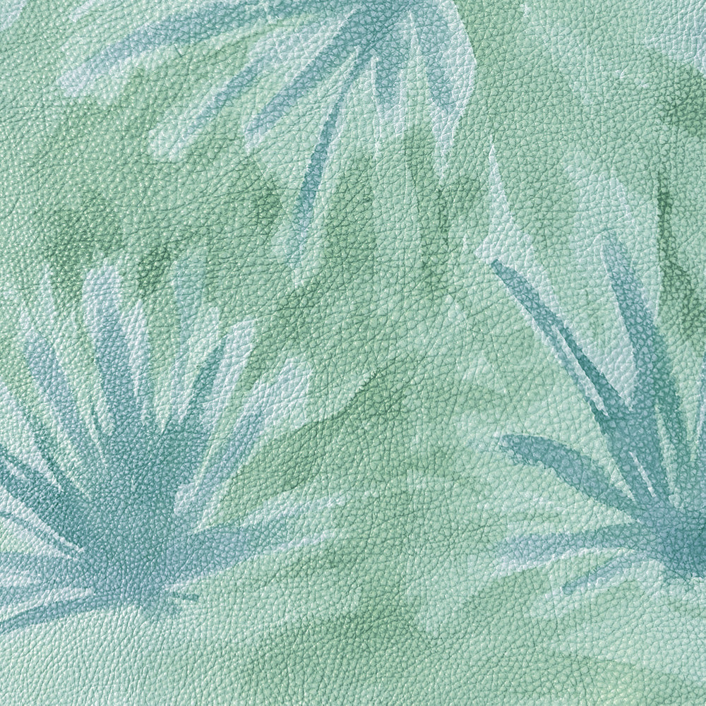 Close-up of upholstery leather in green with a painterly flower print in shades of blue.