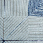 Close-up of a textured rug with blue and gray lines