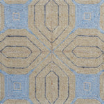 Close-up of a textured rug with geometric pattern in beige and blue