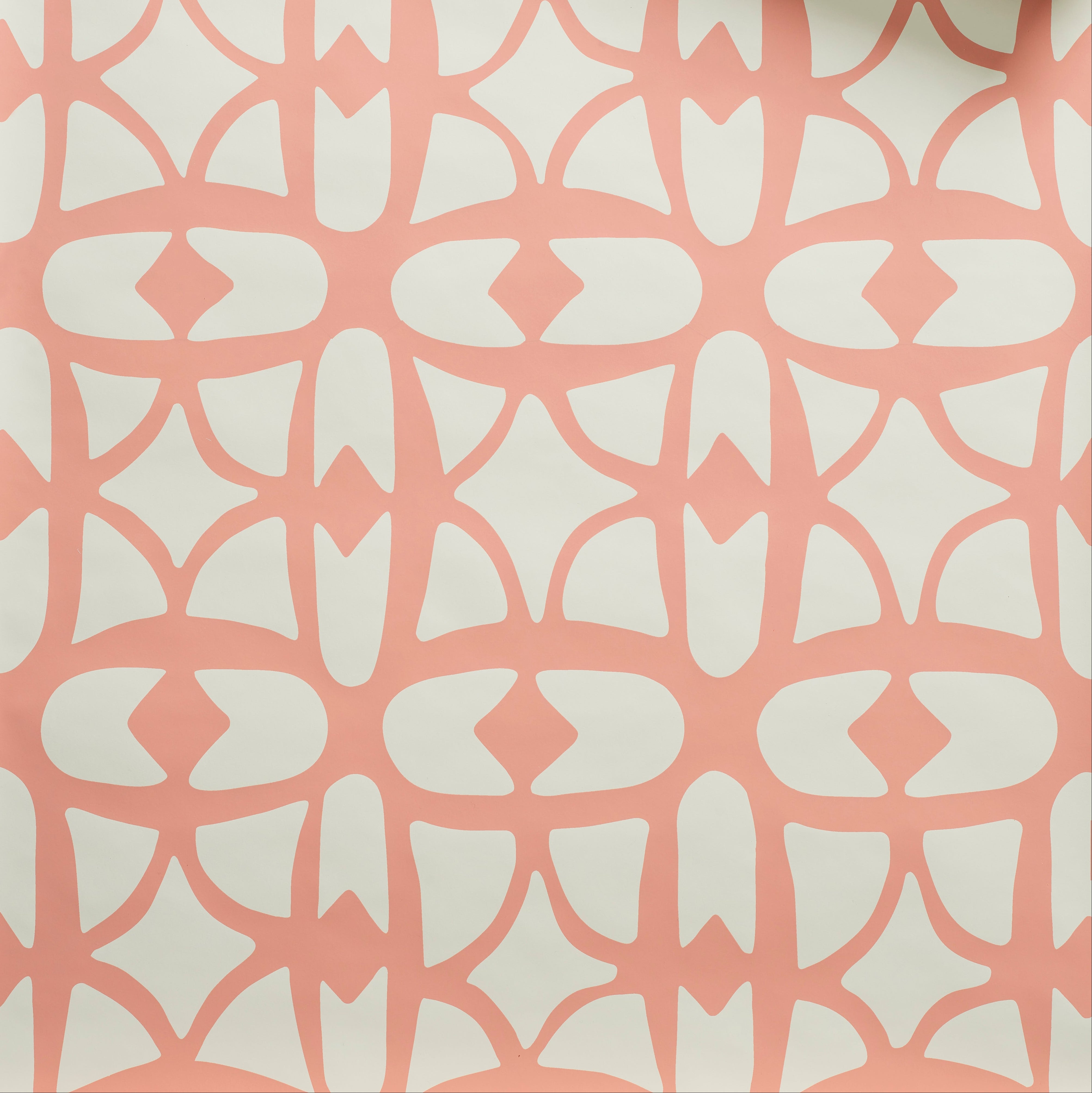 Close up of wallpaper with large scale playful geometric lattice pattern in pink on a white background. 