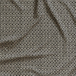 Close up of gently draped fabric with small scale geometric lattice design in beige on black. 
