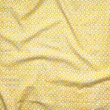 Close up of gently draped fabric with small scale geometric lattice design in white on yellow. 