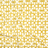 Close up of gently draped fabric with large scale geometric lattice design in white and yellow.