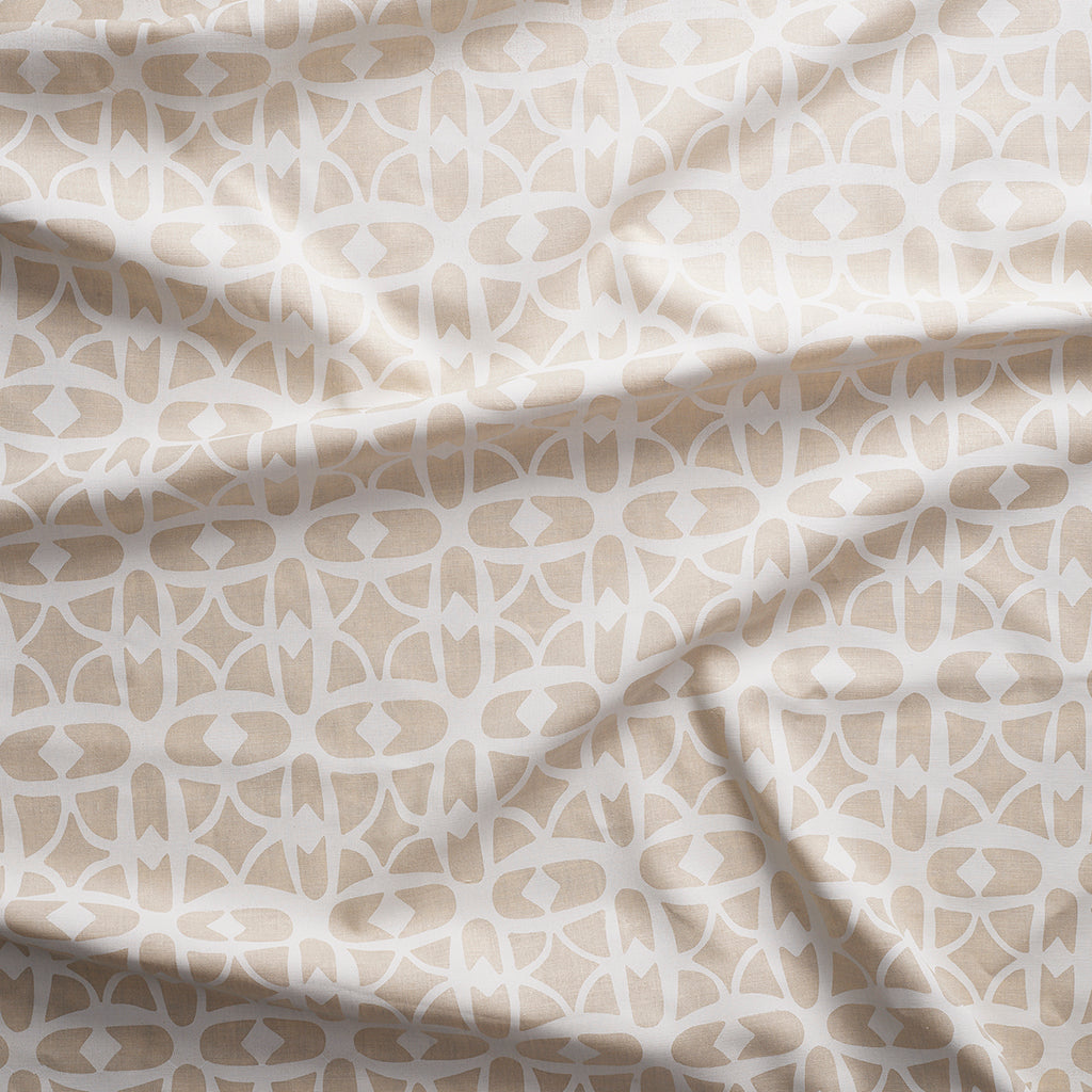 Close up of gently draped fabric with large scale geometric lattice design in white and ecru.