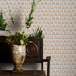 Decorative wallpaper with a subtle floral pattern, a vintage wooden chair, and a plant on a wooden surface.