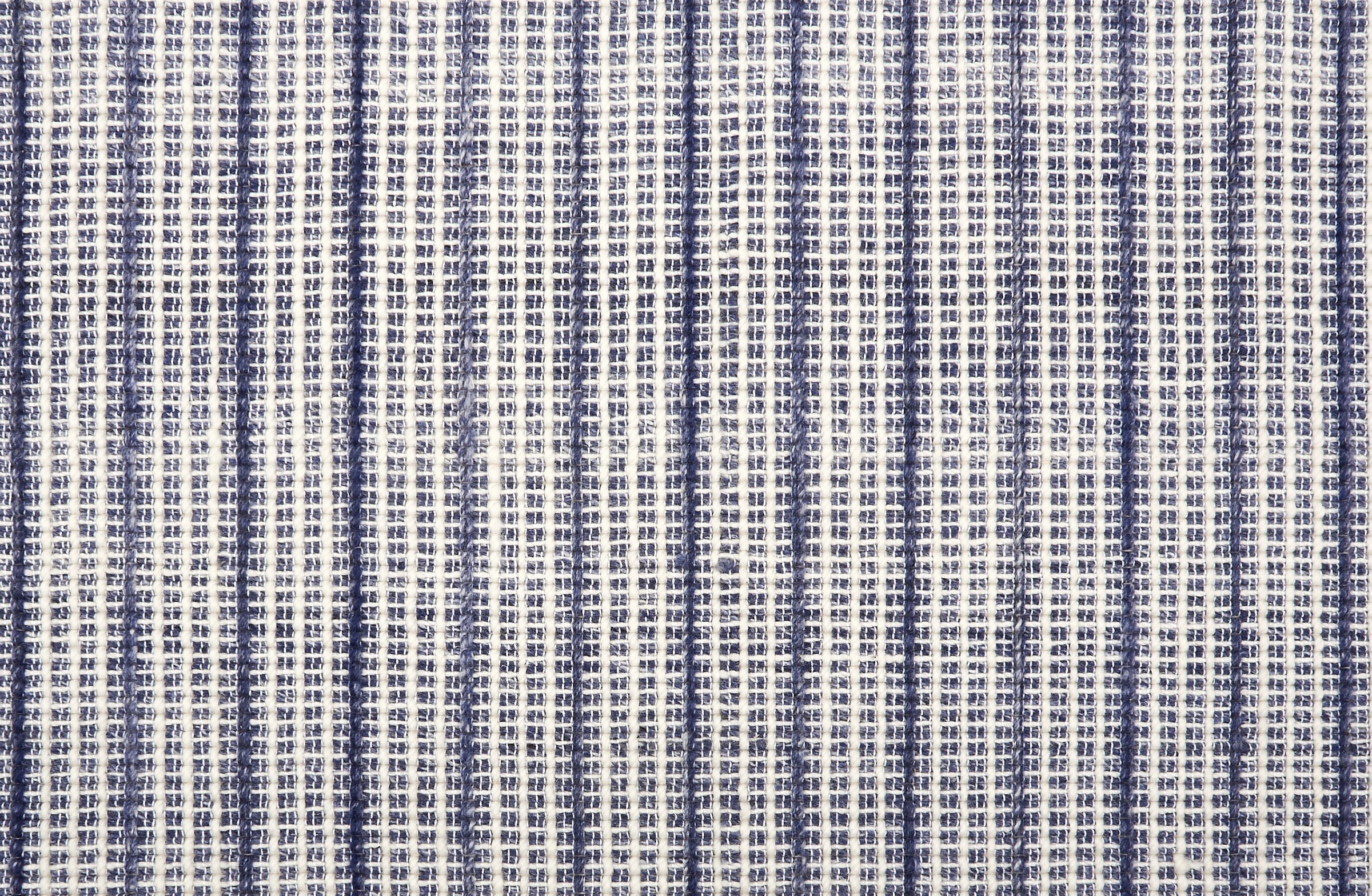 Broadloom carpet in a textural strie stripe in cream with shades of navy blue.