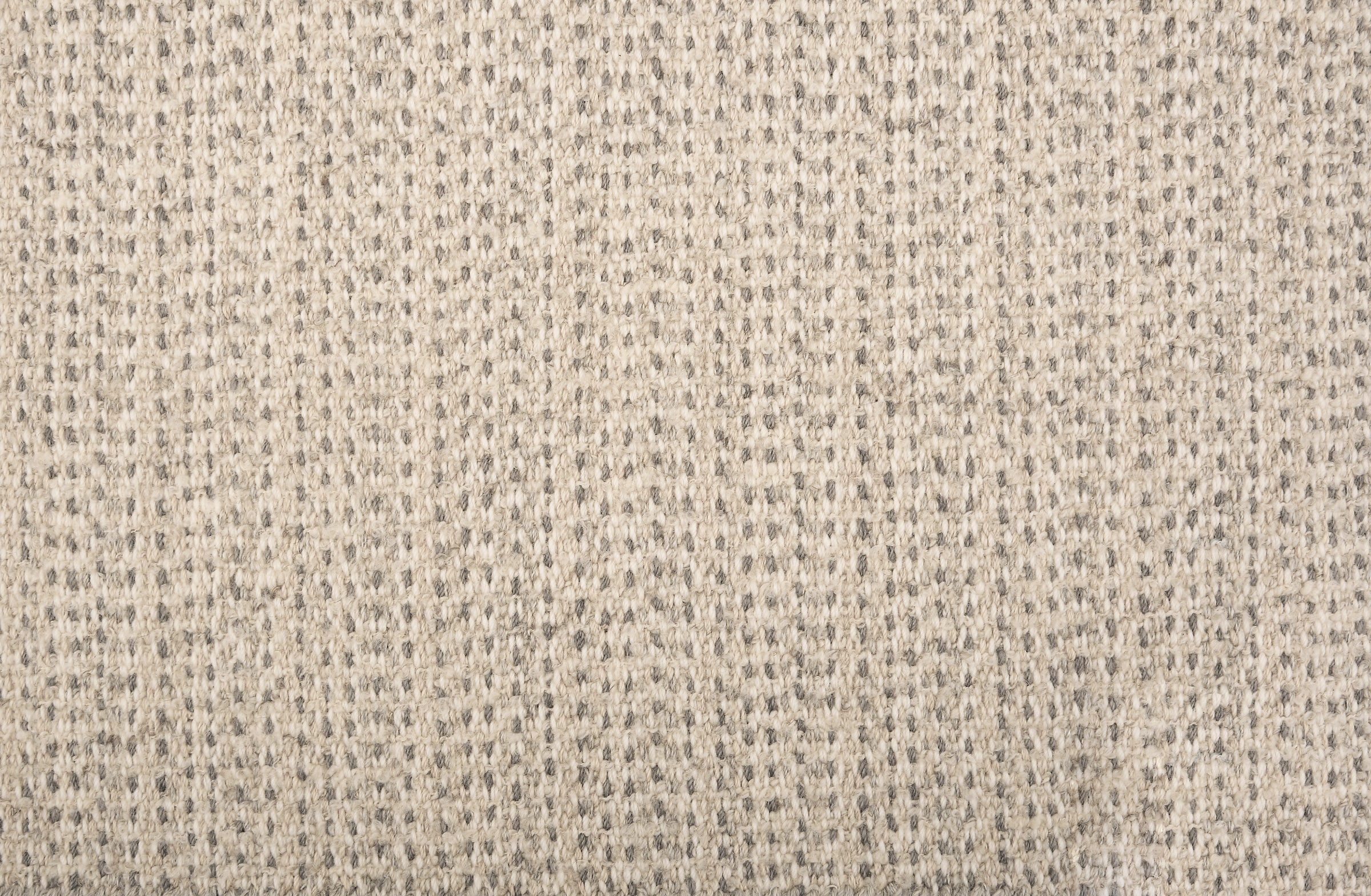 Broadloom carpet in a textural weave in shades of cream and grey. 