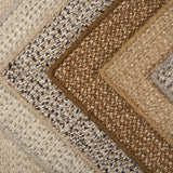 Stack of broadloom carpets in a textural weave in shades of taupe, cream, brown , blue and grey.