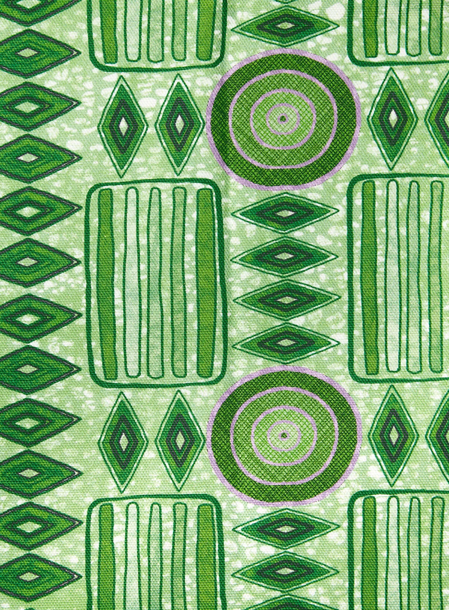 Detail of fabric in a playful geometric stripe print in shades of green with purple accents.