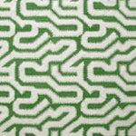 Detail of fabric in a playful meandering print in cream on a green field.