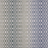 Broadloom carpet with a white checkerboard pattern with an ombré effect in blue and green. 