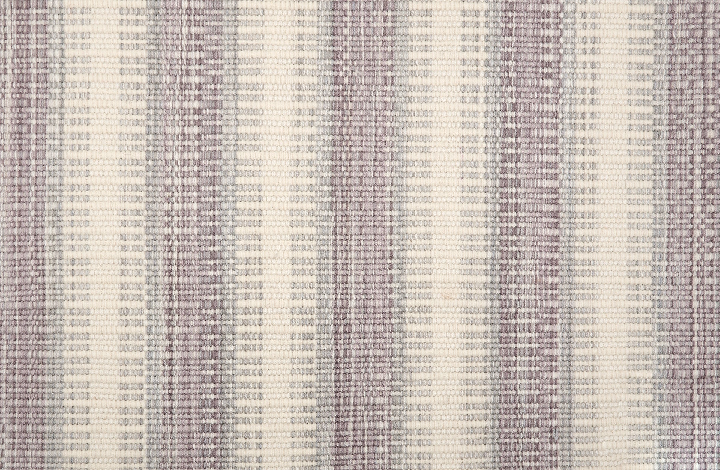 Broadloom carpet in a flatwoven stripe in soft grey, lavender and cream. 