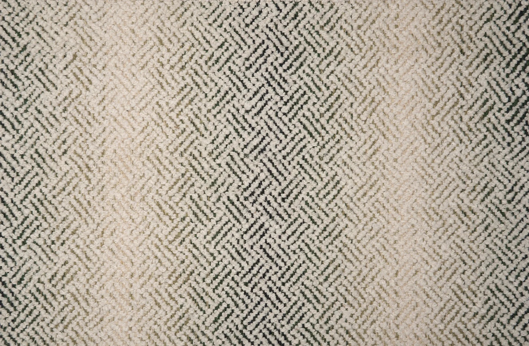 Broadloom with a geometric pattern on an ombré background in cream and emerald green.