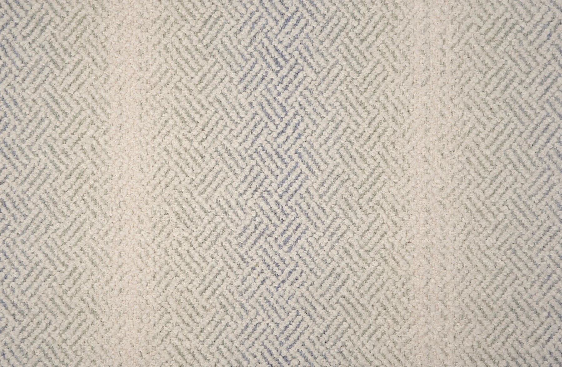 Broadloom with a geometric pattern on an ombré background in cream and grey.