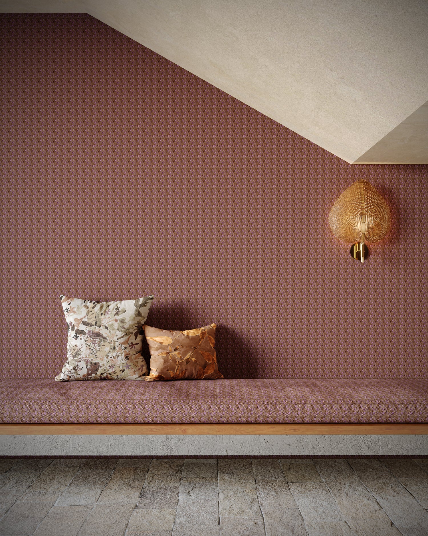 Patterned wall with a bench and decorative pillows in a room with a textured wall and light fixture.