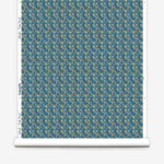 Wallpaper roll with small scale watercolor floral in green on a teal background. 