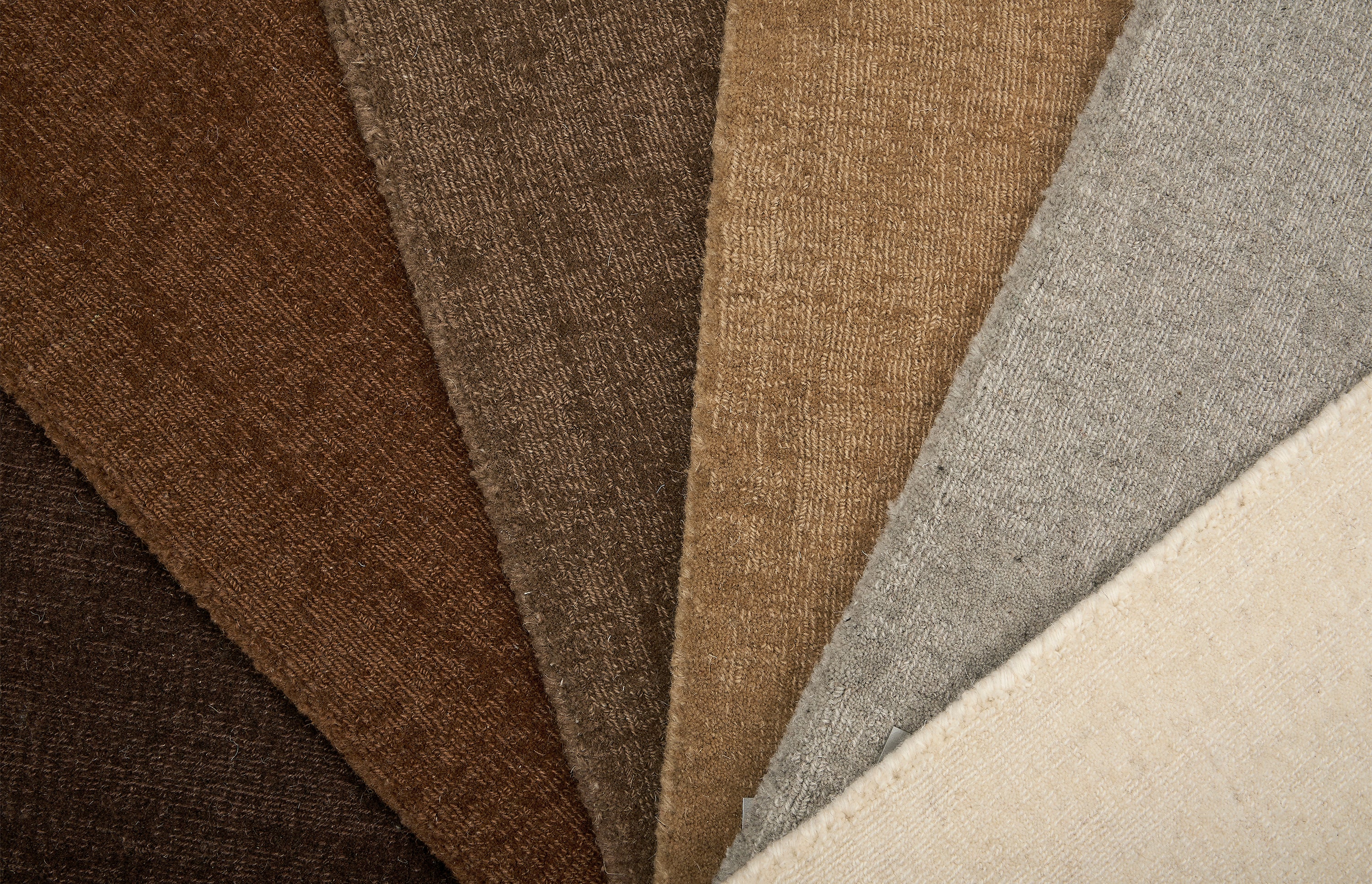 Broadloom carpet in an array of solid neutral colors.