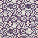 Detail of fabric in a floral damask print in white and red on a purple field.