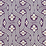 Detail of fabric in a floral damask print in white and red on a purple field.