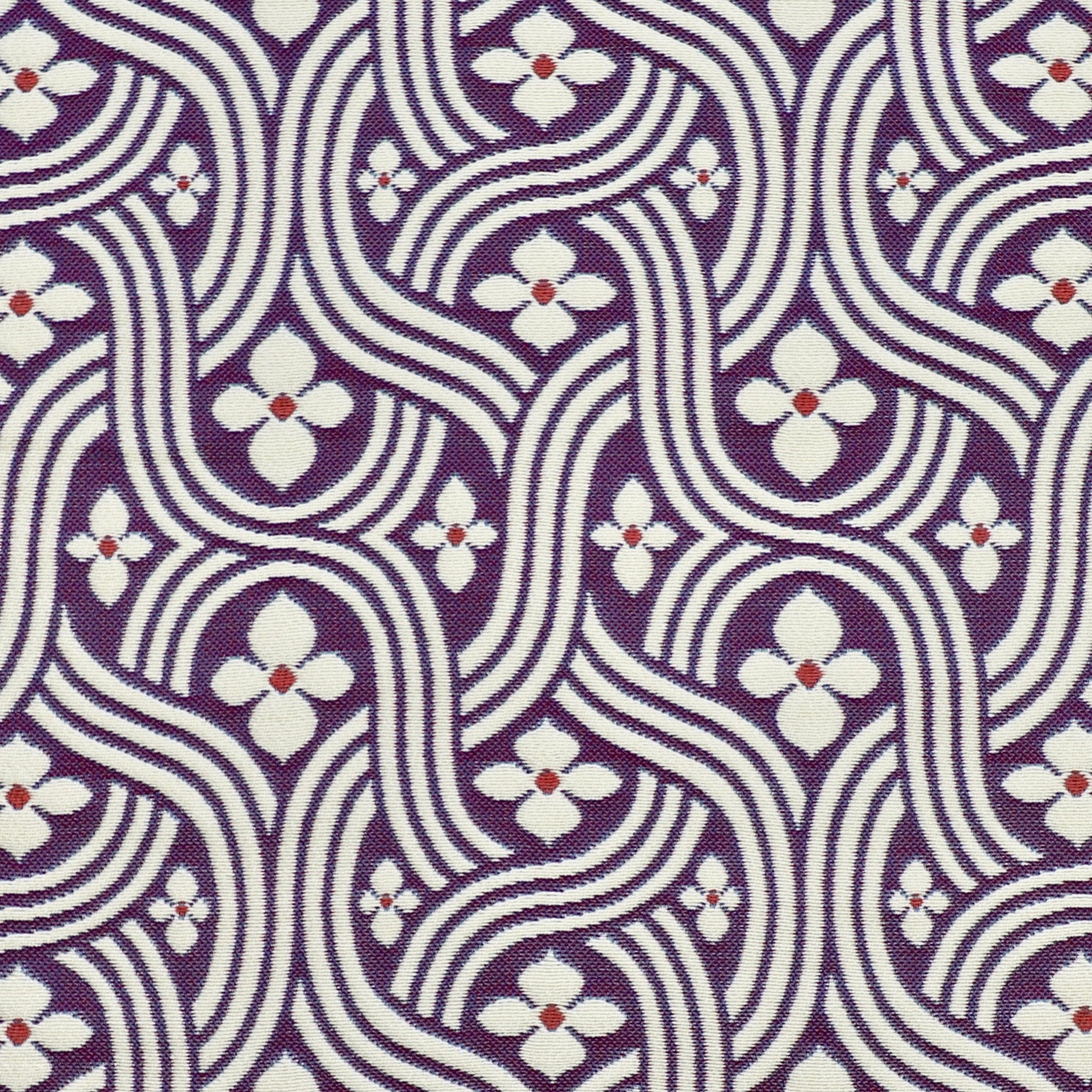 Detail of fabric in a floral damask print in white and red on a purple field.