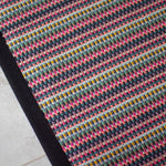 Striped flatweave runner in pink green purple blue with black border 