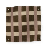 A fabric swatch in a gridded check pattern in brown, cream and mauve. 