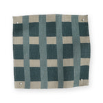 A fabric swatch in a gridded check pattern in cream and turqoise blue. 