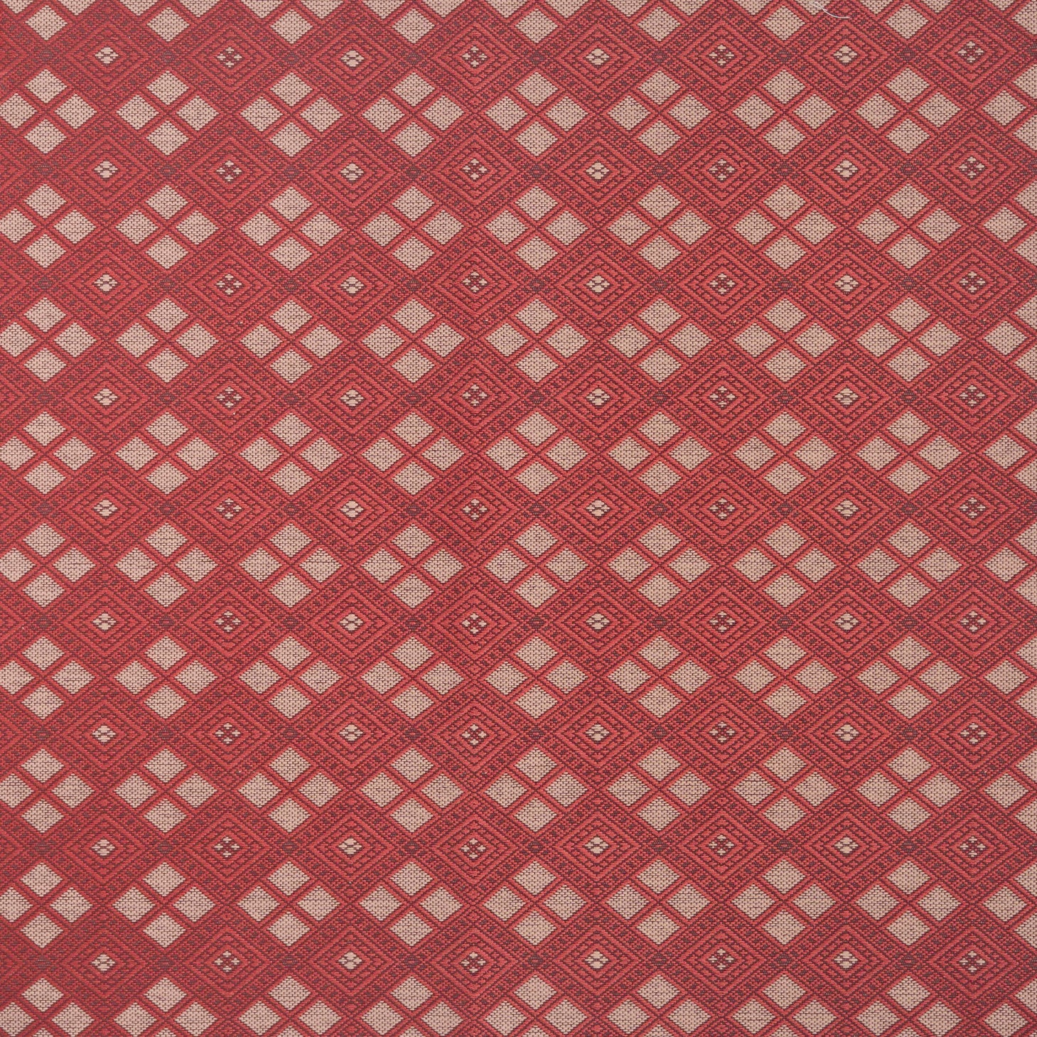 Woven fabric with ornate diamond design with cream accents on red