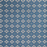 Woven fabric with ornate diamond design with cream accents on blue.