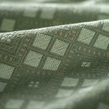 Close-up of textured fabric with geometric pattern in green