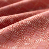 Close-up of red fabric with a diamond pattern