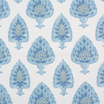 Detail of fabric in a botanical damask print in shades of green and blue on a cream field.