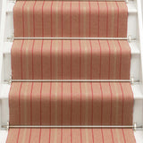Striped flatweave runner in raspberry and red on white staircase