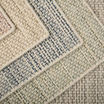 Close-up of various textured rugs with textural stripe patterns in five colors. 