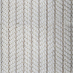 Close-up of a broadloom carpet with vertical stripes in beige and tan