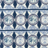 Detail of fabric in an intricate geometric stripe in shades of blue, navy and cream.