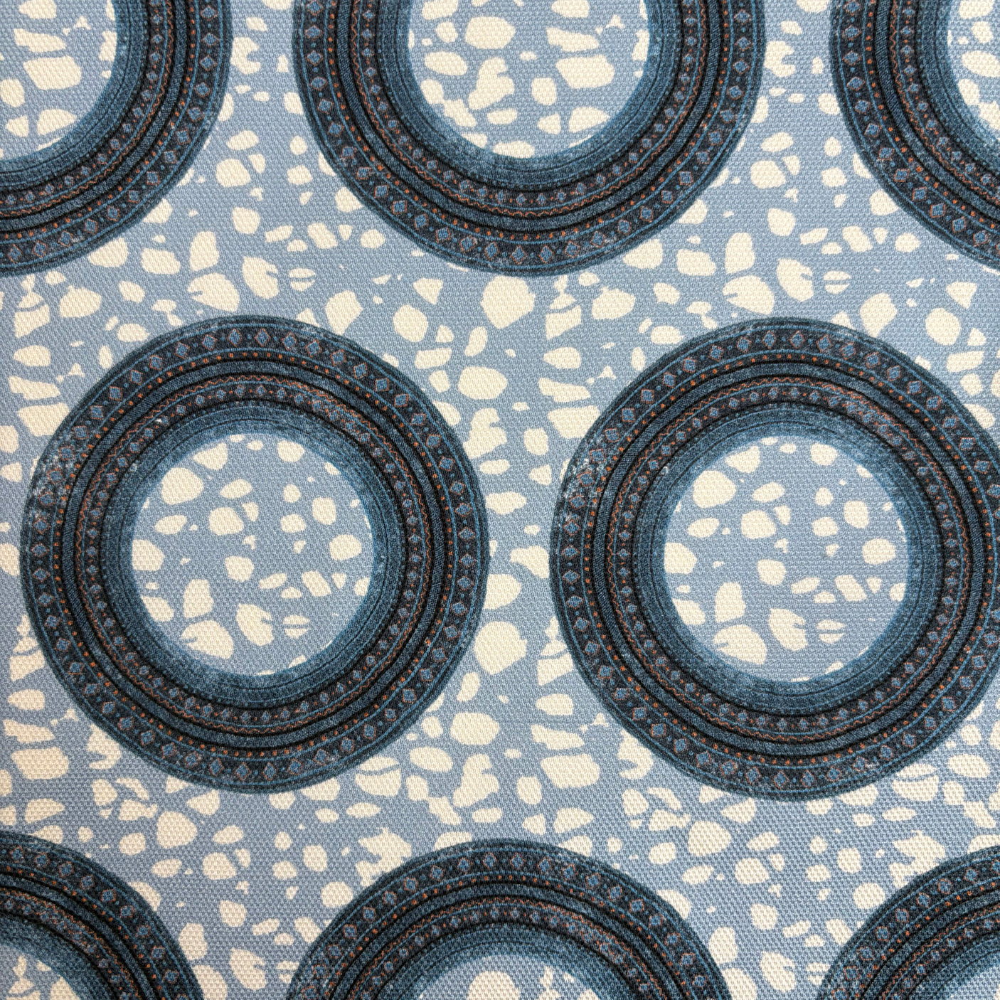 Patterned fabric with circular designs on a blue background