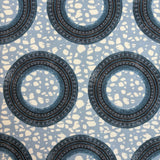 Patterned fabric with circular designs on a blue background