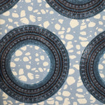 Patterned fabric with circular designs on a blue background