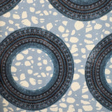 Patterned fabric with circular designs on a blue background