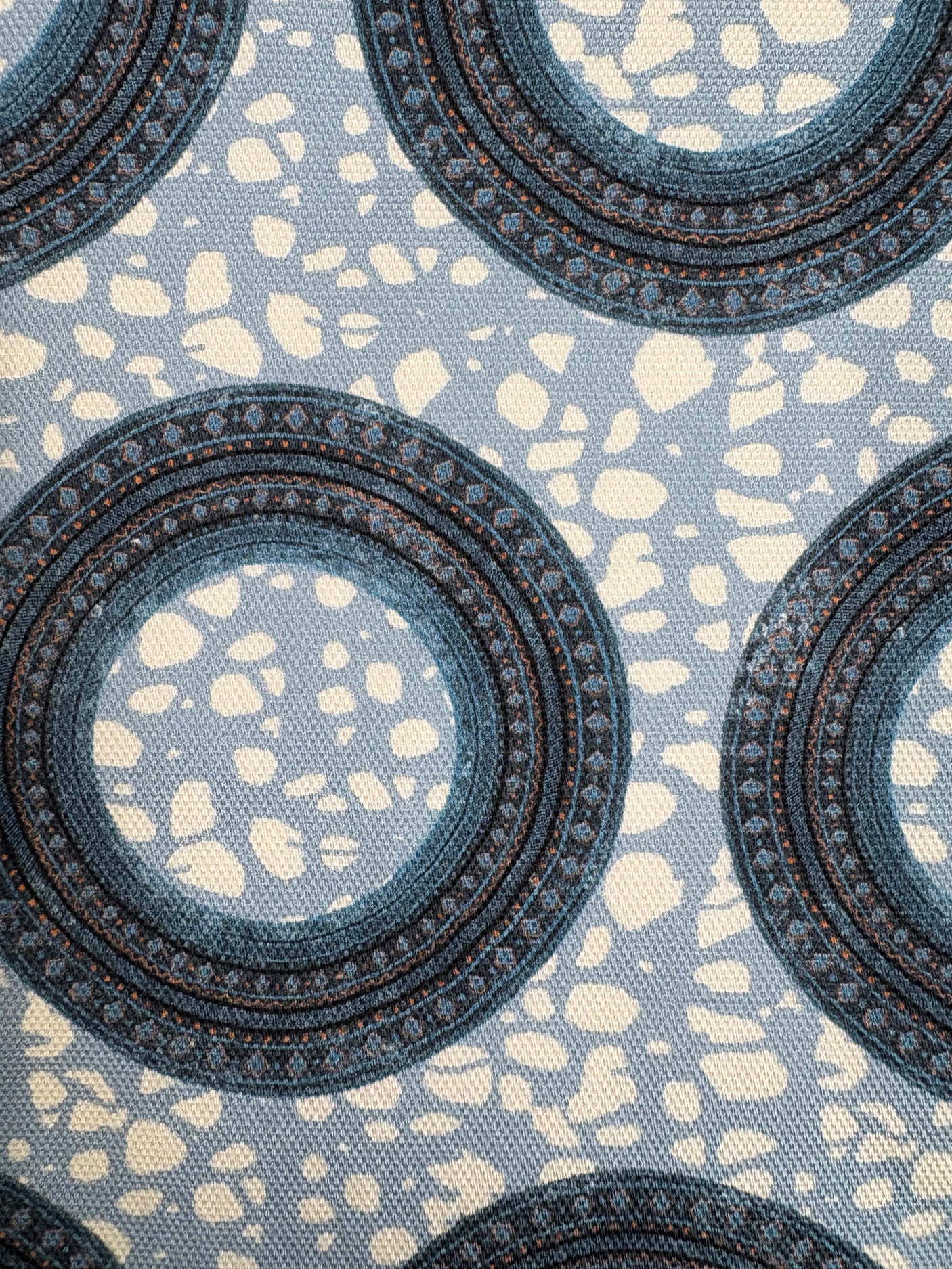 Patterned fabric with circular designs on a blue background