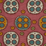 Flatweave rug with a playful polka dot pattern with a mix of sizes in cream and yellow with red outlines and smaller blue, yellow and green dots on a pink field. 